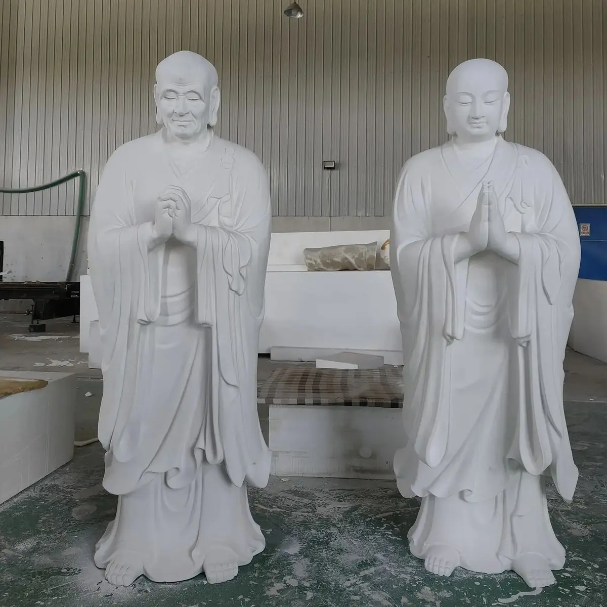 Pair of white arhat sculptures with detailed robe carving