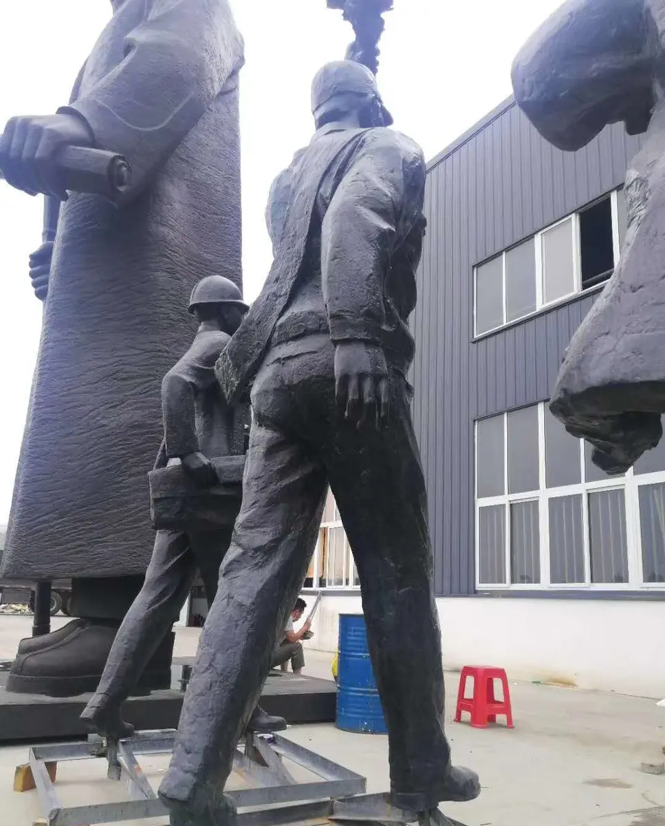 Group of black cast figures in marching poses at the foundry