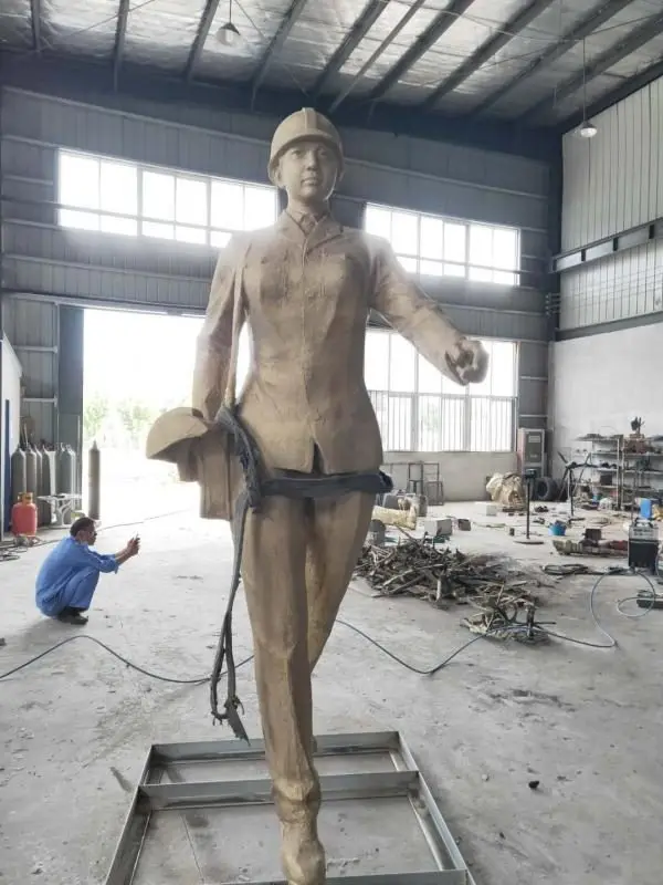 Cast figure of a female engineer in workwear and safety helmet