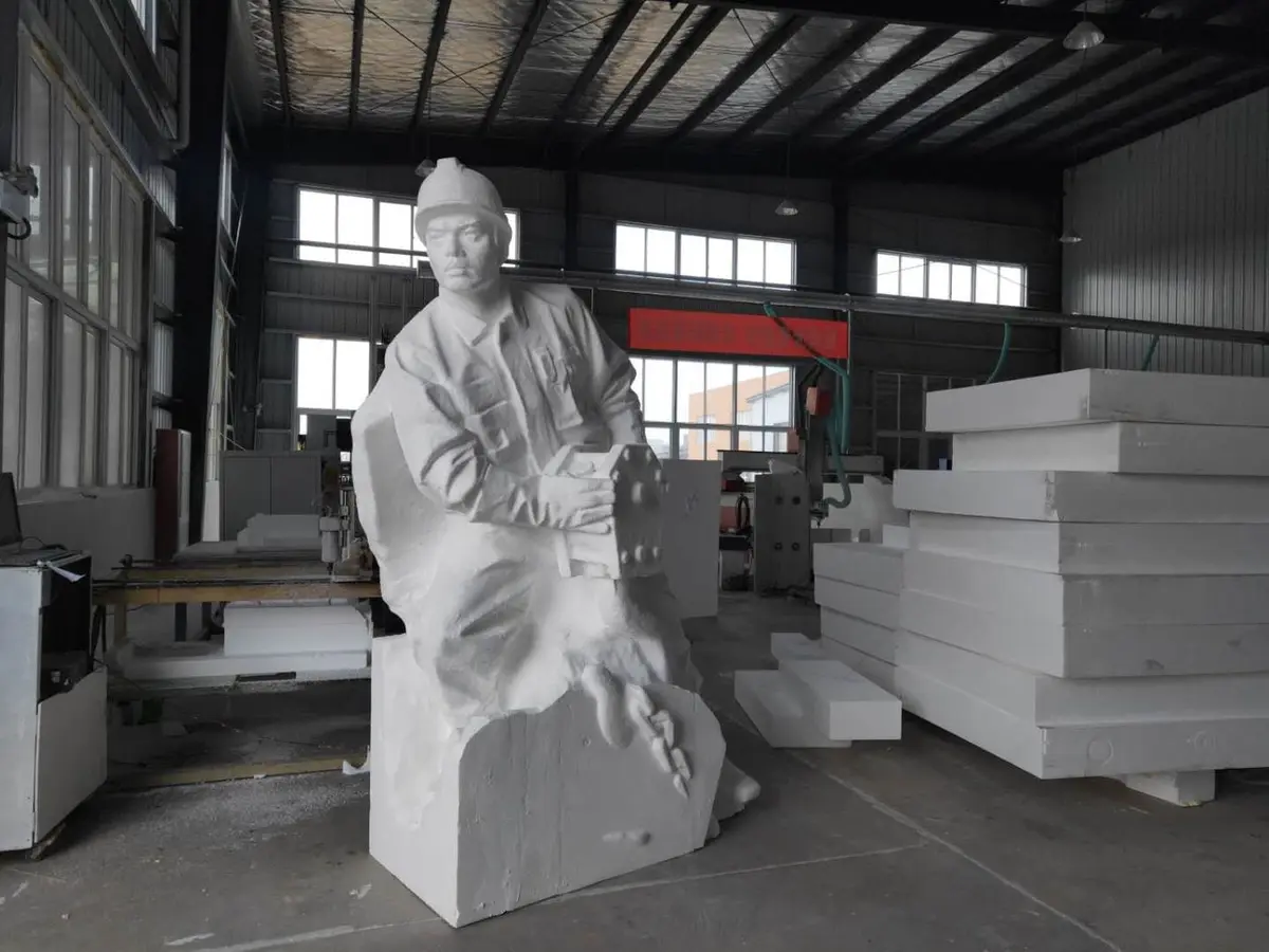 White figure sculpture of a worker in the workshop