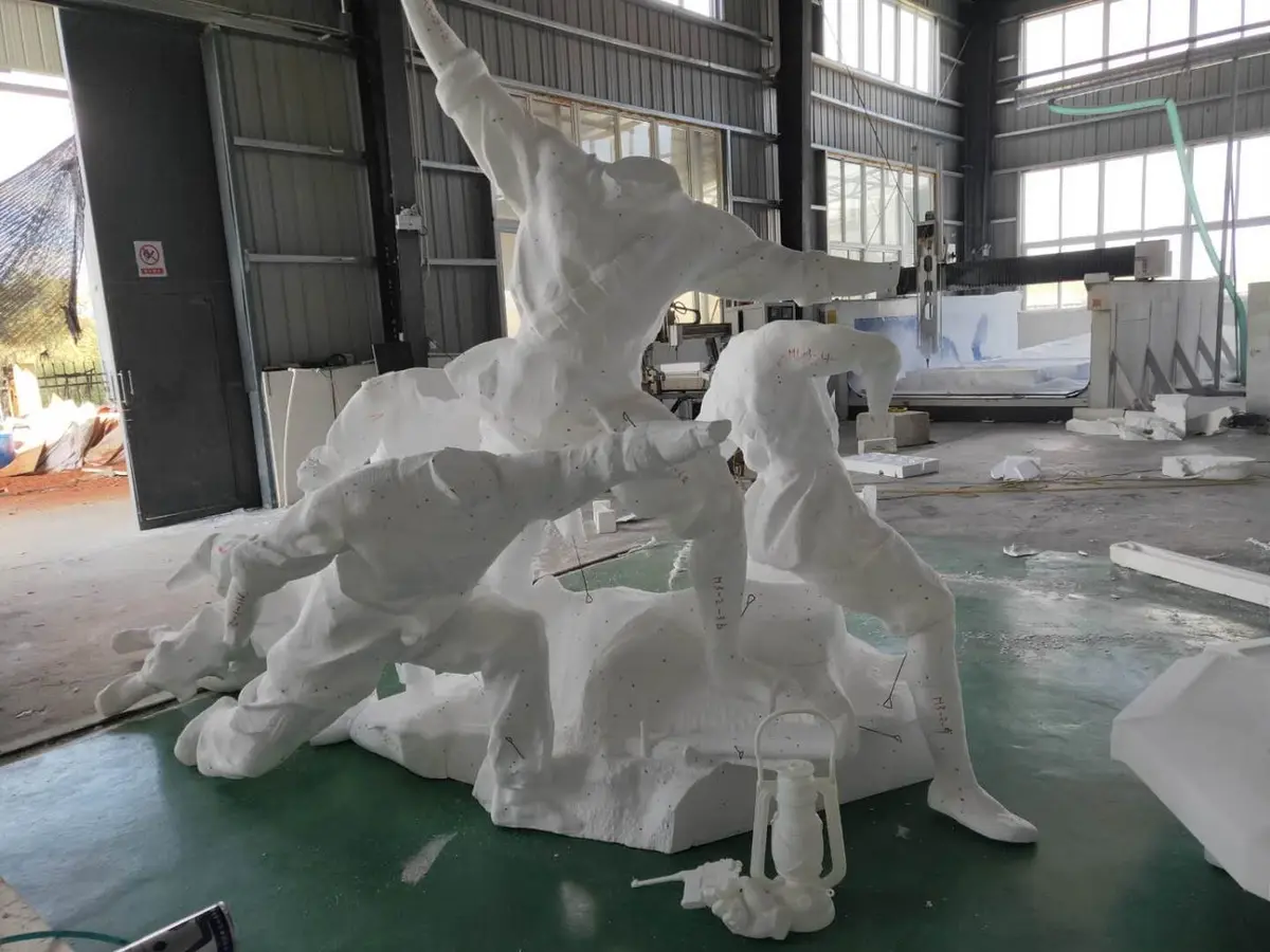White foam master model of a group of figures in dynamic poses