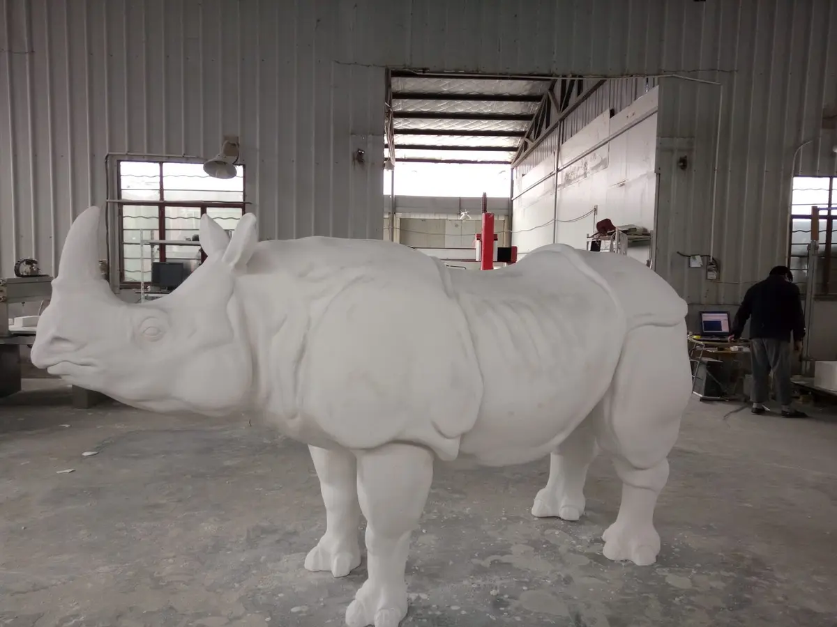 Realistic white foam rhino sculpture with detailed skin texture