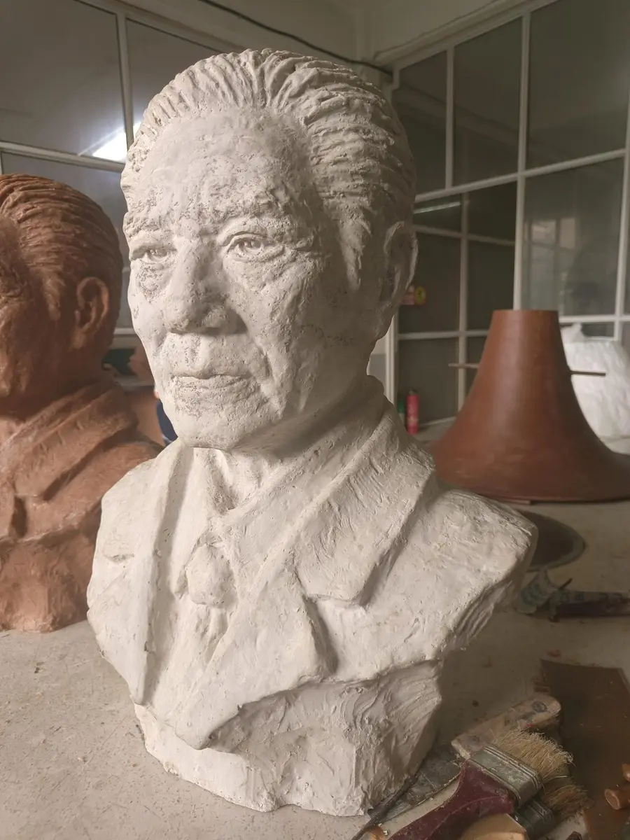 Plaster portrait bust of a gentleman with suit and tie details
