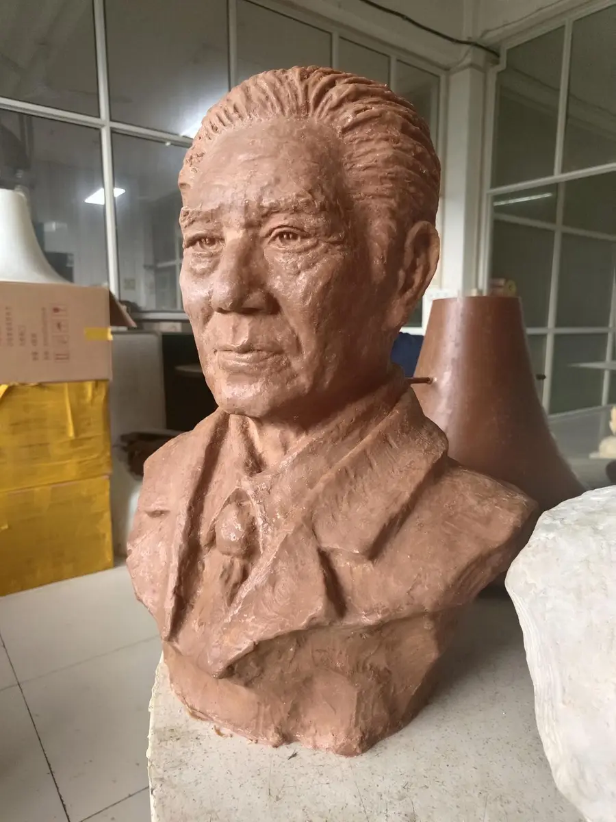 Terracotta portrait bust of a gentleman in a suit and tie