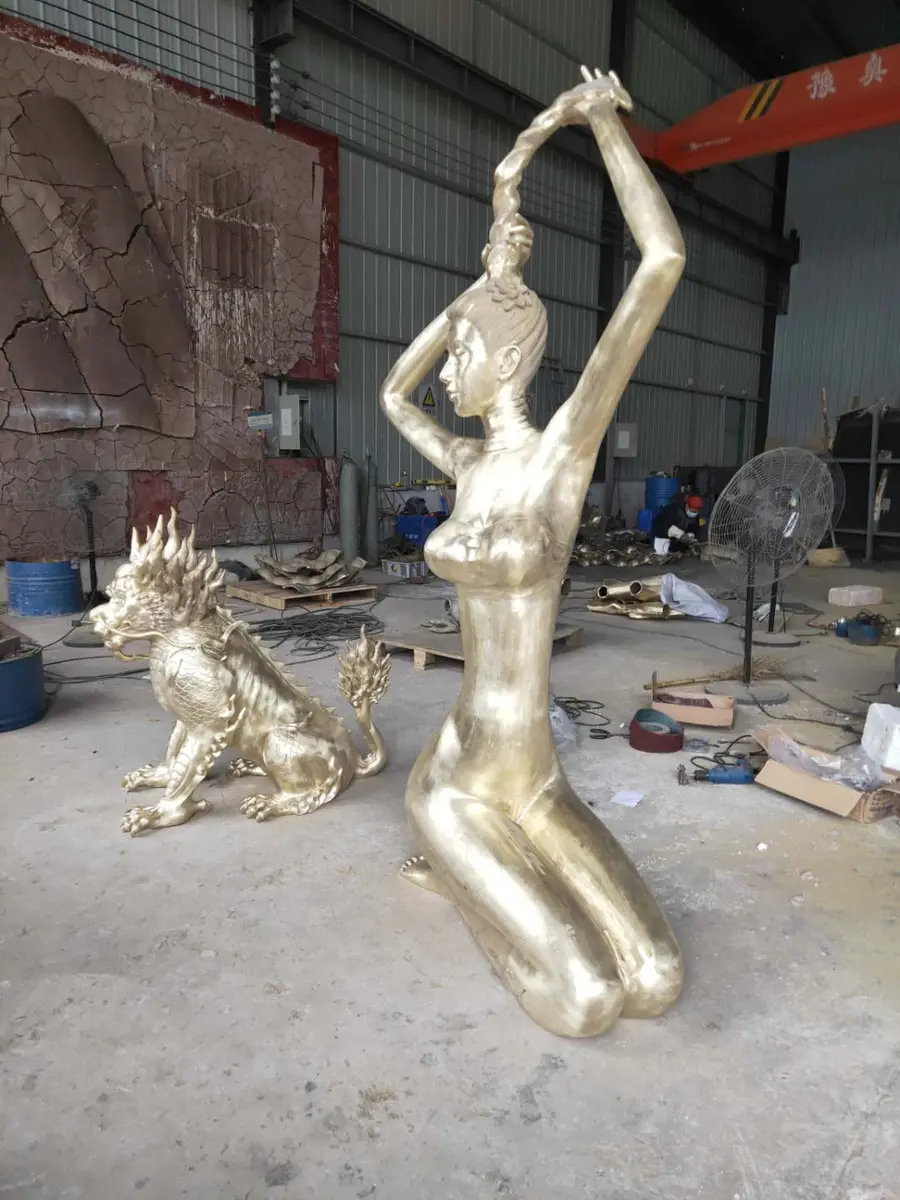 Gold kneeling female figure beside a qilin