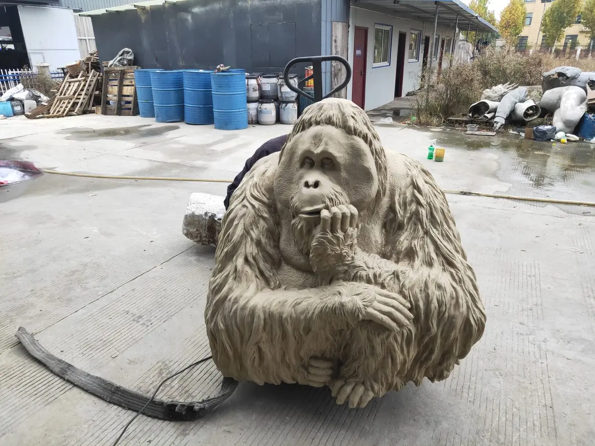 Bronze gorilla sculpture with detailed fur texture, thoughtful pose