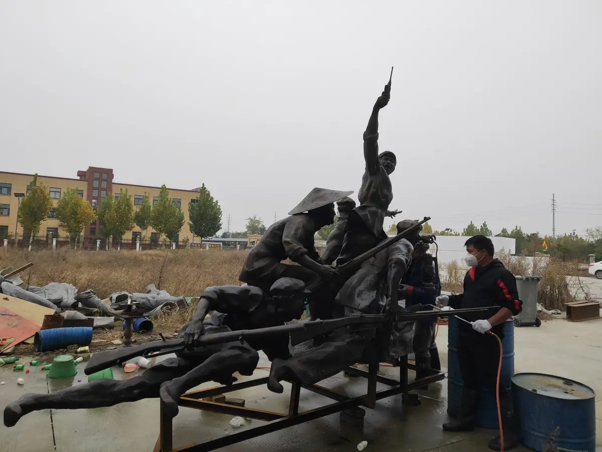 Monumental bronze group sculpture with workers performing maintenance