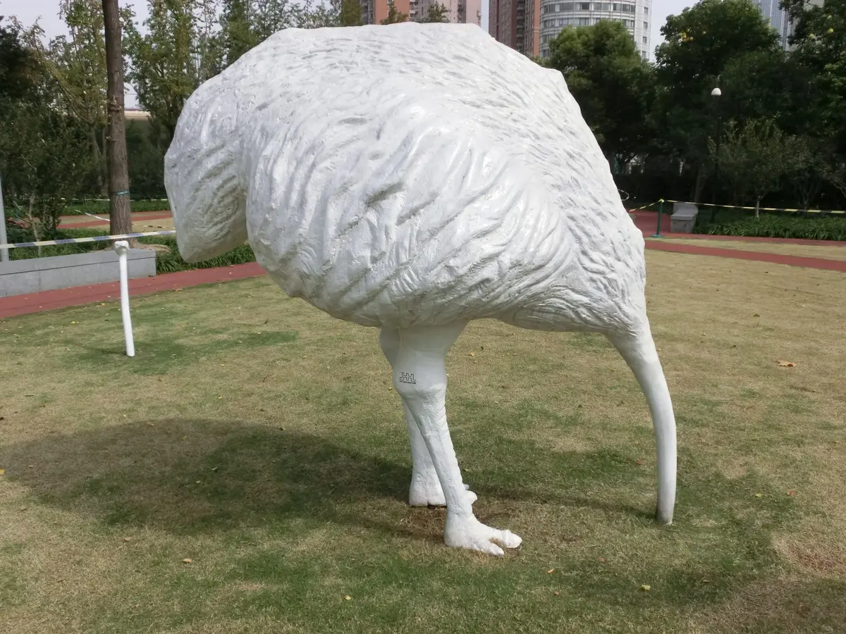 White kiwi bird sculpture on a park lawn