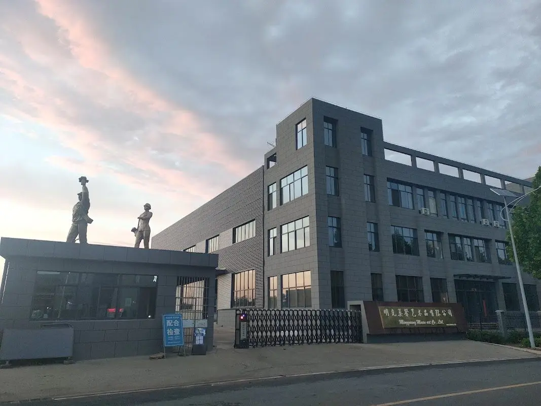 Two bronze figures standing on the factory guard booth