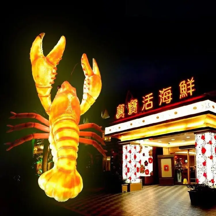Illuminated giant lobster sculpture outside a seafood restaurant