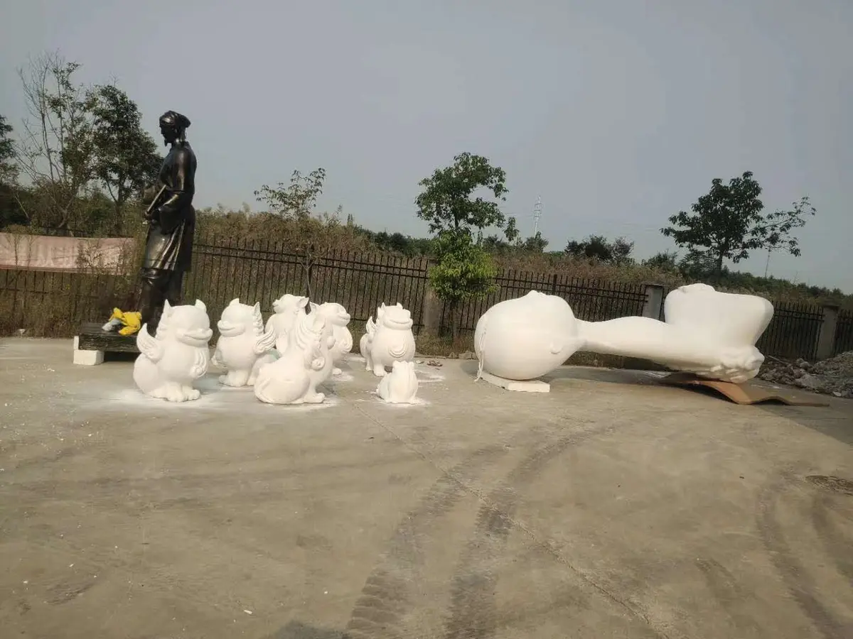Collection of white animal sculptures arranged in the yard